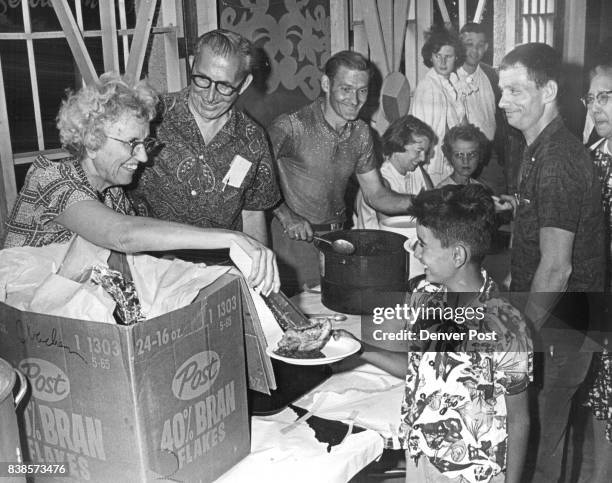 Goodwill Families Relax At Picnic Mrs. Alice Boutellier , 2060 S. Franklin St., Left , serves fried chicken to Eugene Olivros of 2473 Lawrence St.,...