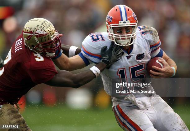Safety Myron Rolle of the Florida State Seminoles tackles quarterback Tim Tebow of the Florida Gators during the first half at Bobby Bowden Field at...