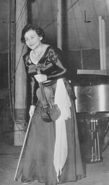 Erica Morini, violinist, takes the first bow at the first con? cert of the Goethe festival at Aspen. She played selections from Tartini, Mozart,...
