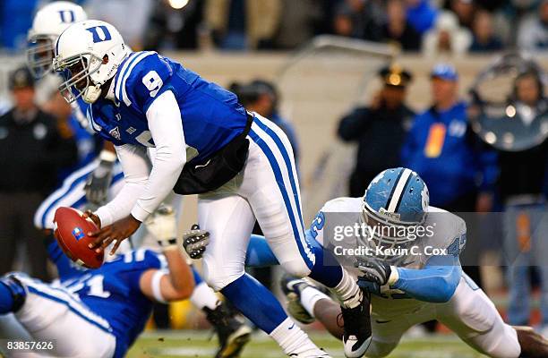 Quarterback Thaddeus Lewis of the Duke Blue Devils is sacked by Robert Quinn of the North Carolina Tar Heels during the game at Wallace Wade Stadium...