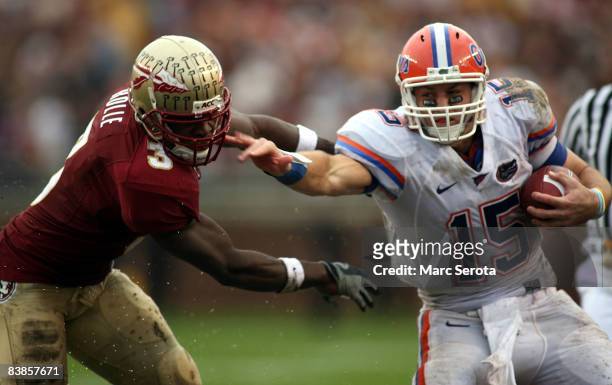 Safety Myron Rolle of the Florida State Seminoles tackles quarterback Tim Tebow of the Florida Gators during the first half at Bobby Bowden Field at...