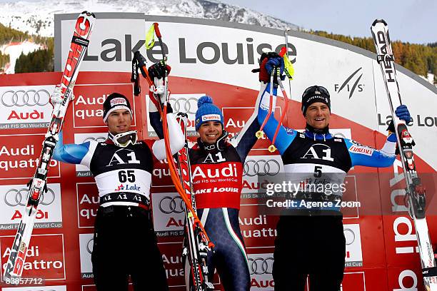 Carlo Janka of Switzerland, 2nd place, Peter Fill of Italy, 1st place, and Hans Olsson of Sweden, 3rd place, celebrate on the podium during the Men's...