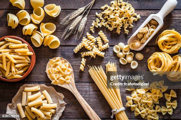 italiaanse pasta collectie op rustieke houten tafel - pasta stockfoto's en -beelden