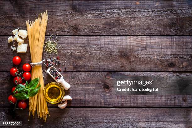 spagetti with ingredients on rustic wooden table - pasta tomato basil stock pictures, royalty-free photos & images