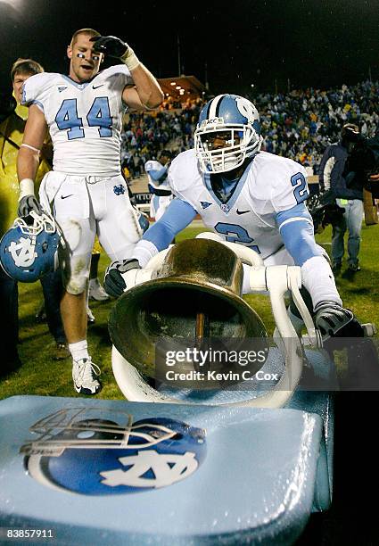 Chase Rice watches as Cooter Arnold of the North Carolina Tar Heels rings the Victory Bell after defeating the Duke Blue Devils 28-20 at Wallace Wade...