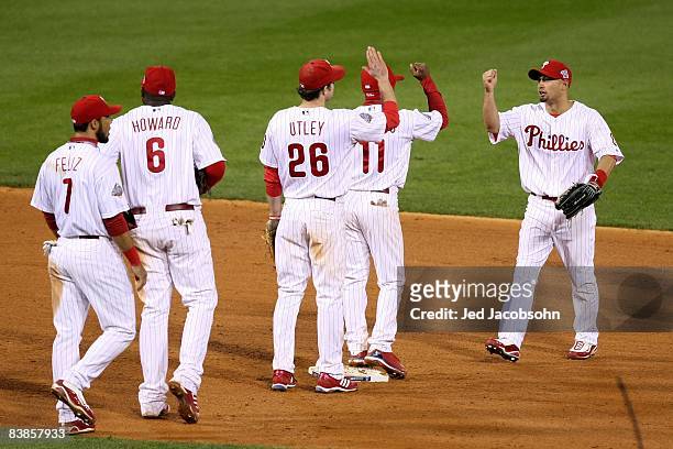 Shane Victorino of the Philadelphia Phillies celebrates with teammates after their 10-2 win against the Tampa Bay Rays during game four of the 2008...
