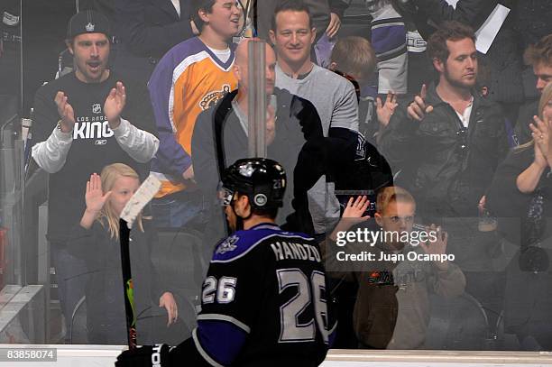 Actor AJ Buckley and Eddi Cahill attends the NHL game between the Chicago Blackhawks and the Los Angeles Kings during the game on November 29, 2008...