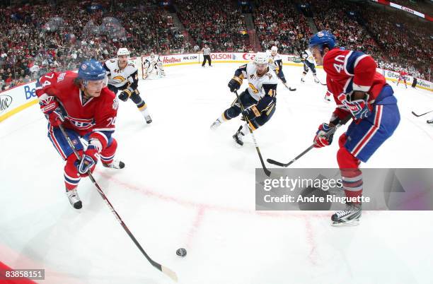 Andrei Kostitsyn and Maxim Lapierre of the Montreal Canadiens cycle the puck against Andrej Sekera and Clarke MacArthur of the Buffalo Sabres at the...