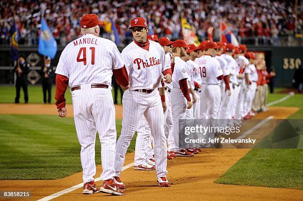 Pat Burrell of the Philadelphia Phillies greets manager Charlie Manuel during player introductions against the Tampa Bay Rays during game four of the...