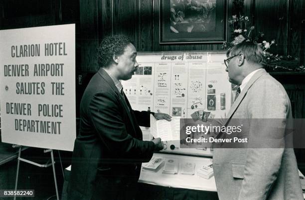 Detective Peter Amory in charge of DPD van ***** displaying to Richard M. Schmidt, Dir of Reg. Sales, Los Angeles, Calif. Credit: The Denver Post