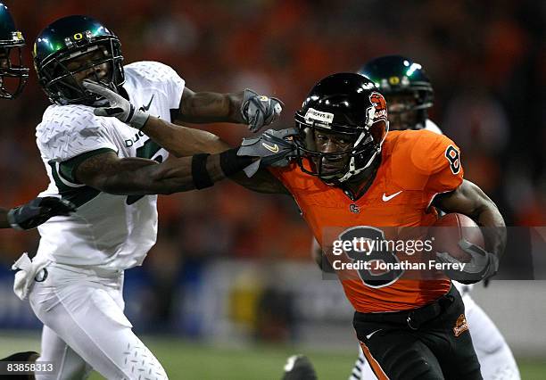 James Rodgers of the Oregon State Beavers is tackled runs with the ball against Remene Alston Jr. #5 of the Oregon Ducks at Reser Stadium on November...