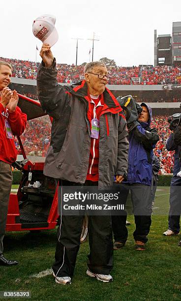 Former long-time Georgia Bulldogs radio announcer Larry Munson acknowledges the crowd during a first half tribute to him during the game against...