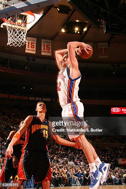 David Lee of the New York Knicks shoots his career all time high of 28 points against Andris Biedrins of the Golden State Warriors on November 29,...