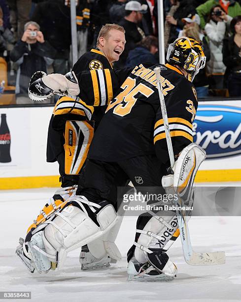 Tim Thomas of the Boston Bruins laughs with Manny Fernandez after a win against the Detroit Red Wings at the TD Banknorth Garden on November 29, 2008...