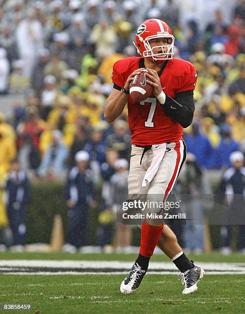 Quarterback Matthew Stafford of the Georgia Bulldogs drops back to pass during the game against the Georgia Tech Yellow Jackets during the game at...