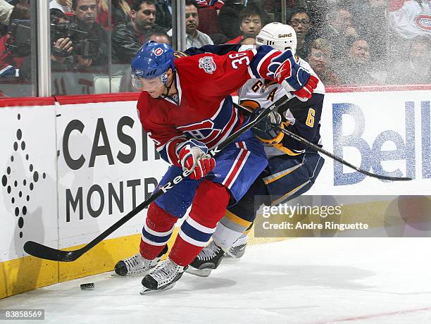 Matt D'Agostini of the Montreal Canadiens digs for the puck against Jaroslav Spacek of the Buffalo Sabres at the Bell Centre on November 29, 2008 in...