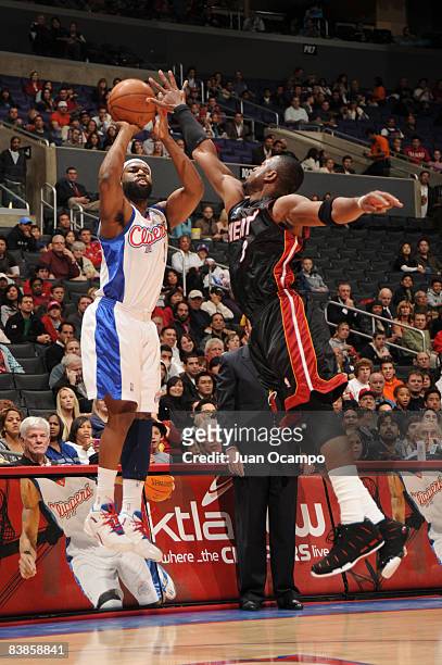 Baron Davis of the Los Angeles Clippers shoots against Dwyane Wade of the Miami Heat at Staples Center on November 29, 2008 in Los Angeles,...