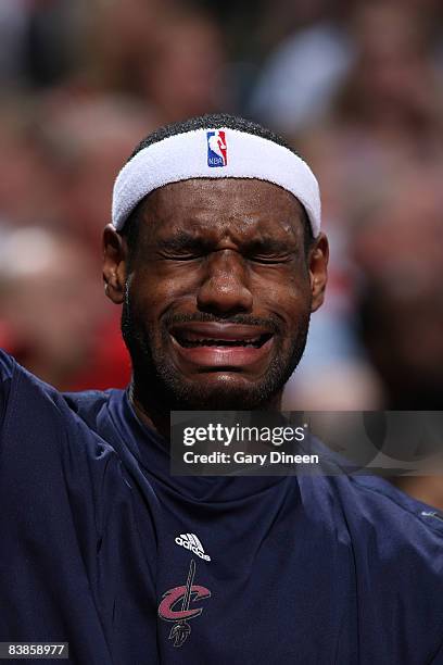 LeBron James of the Cleveland Cavaliers pretends to cry on the bench during the NBA game against the Milwaukee Bucks on November 29, 2008 at the...