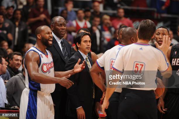 Baron Davis of the Los Angeles Clippers argues a call while Head Coach Erik Spoelstra of the Miami Heat looks on during the fourth quarter of their...