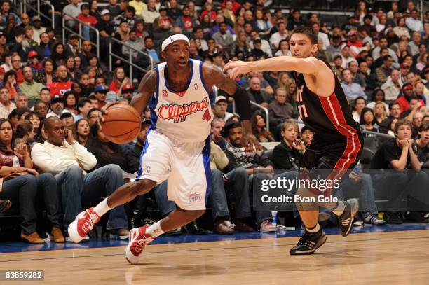 Mike Taylor of the Los Angeles Clippers handles the ball against Chris Quinn of the Miami Heat at Staples Center on November 29, 2008 in Los Angeles,...