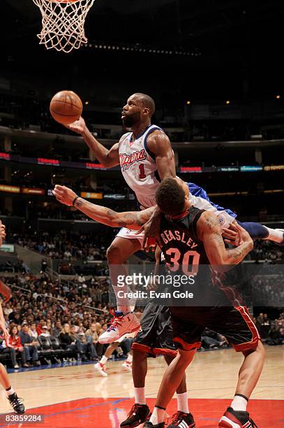 Baron Davis of the Los Angeles Clippers runs into Michael Beasley of the Miami Heat while attempting a shot during their game at Staples Center on...