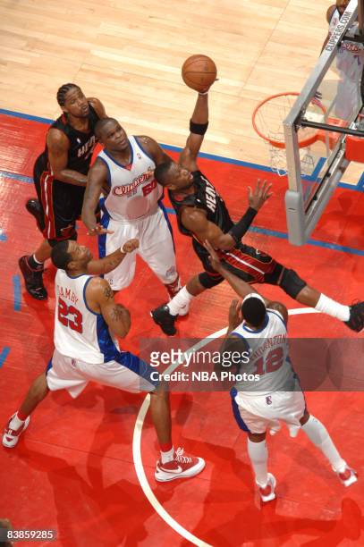 Dwyane Wade of the Miami Heat goes up for a shot between Zach Randolph, Marcus Camby, and Al Thornton of the Los Angeles Clippers at Staples Center...