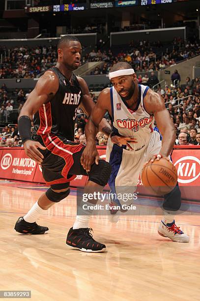 Baron Davis of the Los Angeles Clippers dribbles the ball against Dwyane Wade of the Miami Heat at Staples Center on November 29, 2008 in Los...