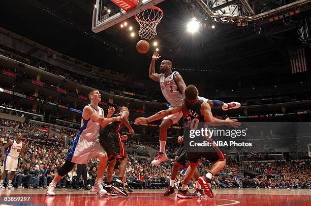 Baron Davis of the Los Angeles Clippers runs into Michael Beasley of the Miami Heat while attempting a shot during their game at Staples Center on...