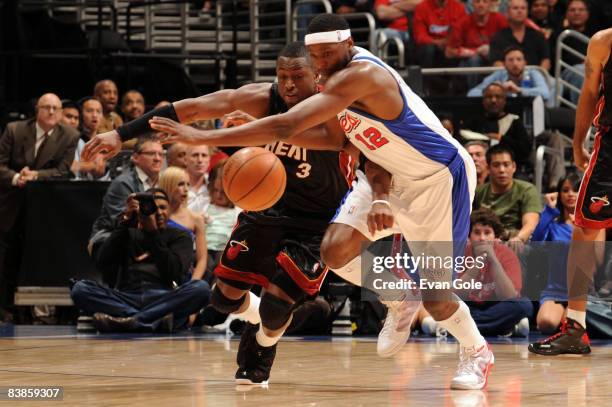 Dwyane Wade of the Miami Heat and Al Thornton of the Los Angeles Clippers chase after a loose ball during their game at Staples Center on November...