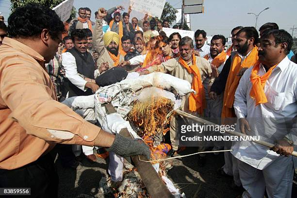 Indian activists of the right-wing Hindu Shiv Sena organization burn an effigy of Pakistan's Inter-Services Intelligence agency during a...