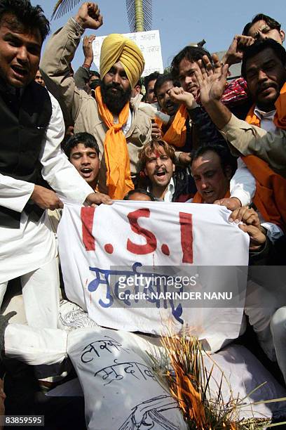 Indian activists of the right-wing Hindu Shiv Sena organization shout slogans burn an effigy of Pakistan's Inter-Services Intelligence agency during...