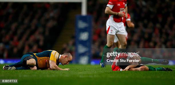 Australian captain Stirling Mortlock and Jamie Roberts lie injured after colliding during the Invesco Perpetual Series match between Wales and...