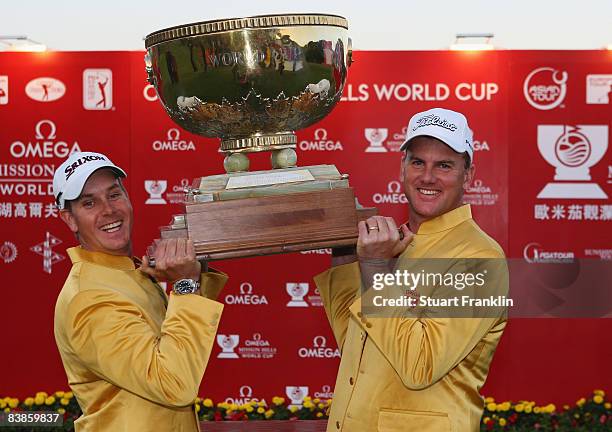 Henrik Stenson and Robert Karlsson of Sweden celebrates with the trophy after winning the final round of the Omega Mission Hills World Cup at the...