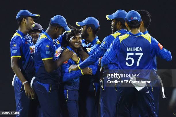 Sri Lanka's Akila Dananjaya celebrates with teammates after he dismissed Indian cricket captain Virat Kohli during the second One Day International...