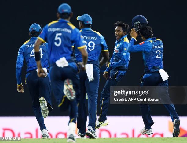 Sri Lanka's Akila Dananjaya celebrates with his teammates after he dismissed Indian cricket captain Virat Kohli during the second One Day...