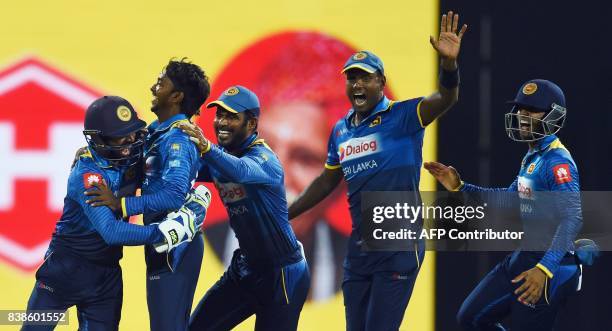 Sri Lanka's cricketer Akila Dananjaya celebrates with teammates after he dismissed Indian cricket Lokesh Rahu during the second One Day International...