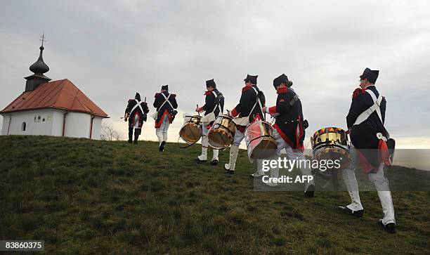 History enthusiasts of Belgium dressed as soldiers of French army march to a hill after the re-enactment of Napoleon I's 1805 Battle of Austerlitz...