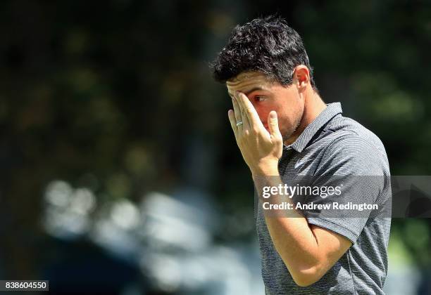 Rory McIlroy of Northern Ireland reacts after putting on the 18th green during round one of The Northern Trust at Glen Oaks Club on August 24, 2017...