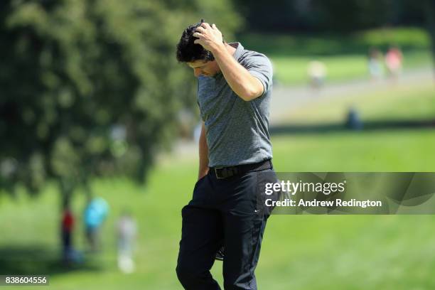 Rory McIlroy of Northern Ireland reacts after putting on the 18th green during round one of The Northern Trust at Glen Oaks Club on August 24, 2017...