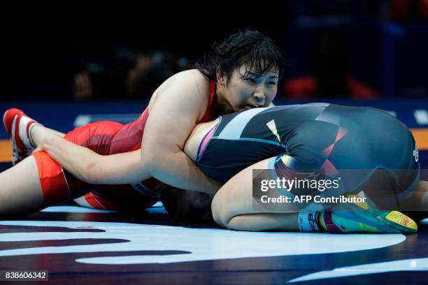 Japan's Sara Dosho competes with Germany's Aline Focken during the women's freestyle wrestling -69kg category final at the FILA World Wrestling...