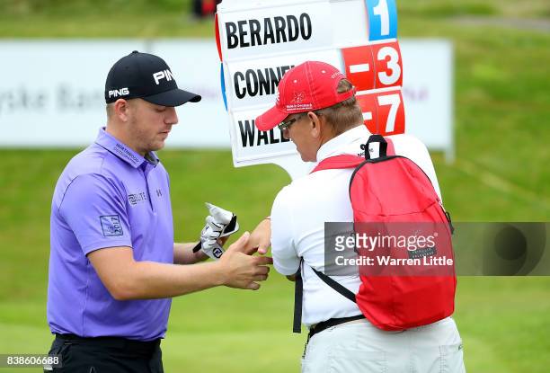 Matt Wallace of England gives a signed glove to the marshall who found his ball on the 18th hole during day one of Made in Denmark at Himmerland Golf...