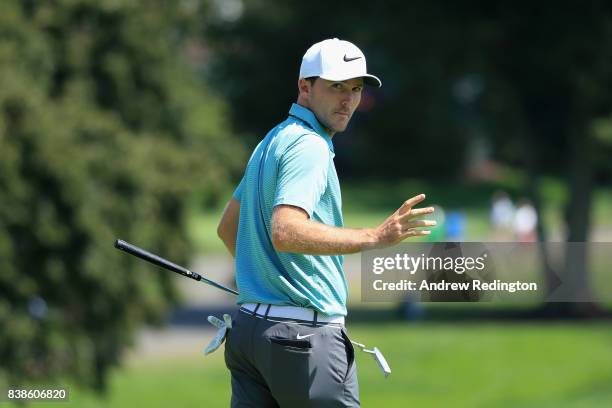 Russell Henley of the United States reacts after putting for birdie on the 18th green during round one of The Northern Trust at Glen Oaks Club on...