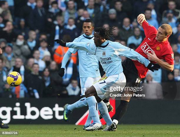 Nemanja Vidic of Manchester United clashes with Benjani of Manchester City during the Barclays Premier League match between Manchester City and...