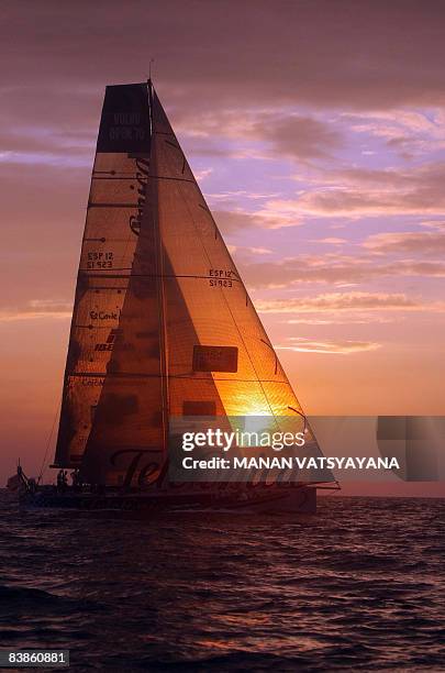 Crew members of the yacht Telefonica Blue relax onboard after finishing in second place at Port Cochin in Kochi on November 30 in leg two of the...