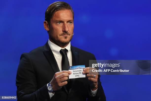 Italian former football player Francesco Totti shows the sheet of paper bearing the name of Tottenham Hotspur FC during the UEFA Europa League group...