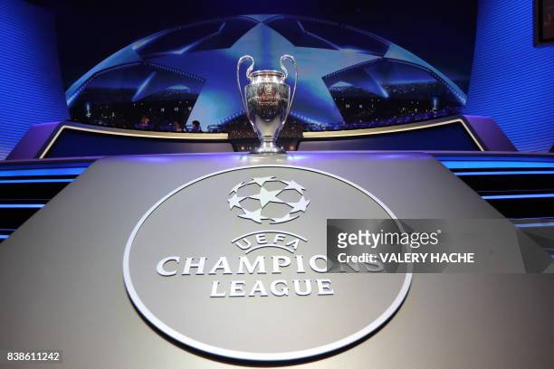 The Champions League Trophy stands on display during the UEFA Champions League football group stage draw ceremony in Monaco on August 24, 2017. / AFP...