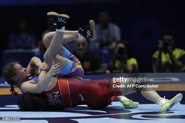 Japan's Yui Susaki competes with Romania's Emilia Alina Vic during the women's freestyle wrestling -48kg category final of the FILA World Wrestling...