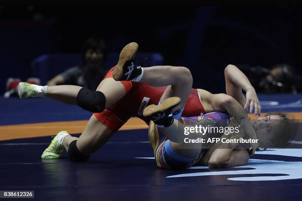 Japan's Yui Susaki competes with Romania's Emilia Alina Vic during the women's freestyle wrestling -48kg category final of the FILA World Wrestling...