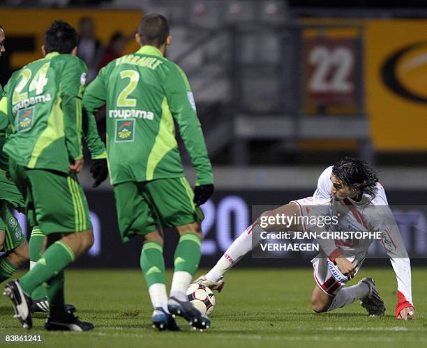 Nancy's forward Youssouf Hadji fights for the ball with Saint Etienne's defenders Cedric Varraullt and Loic Perrin during their French L1 football...