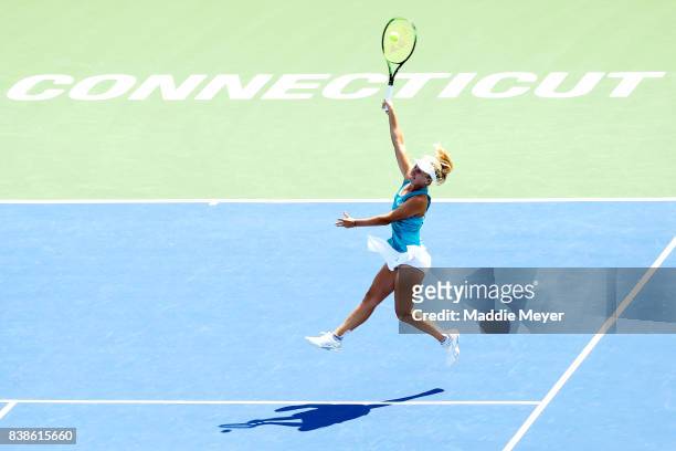 Daria Gavrilova of Australia jumps to returns a shot to Kirsten Flipkens of Belgium during Day 7 of the Connecticut Open at Connecticut Tennis Center...